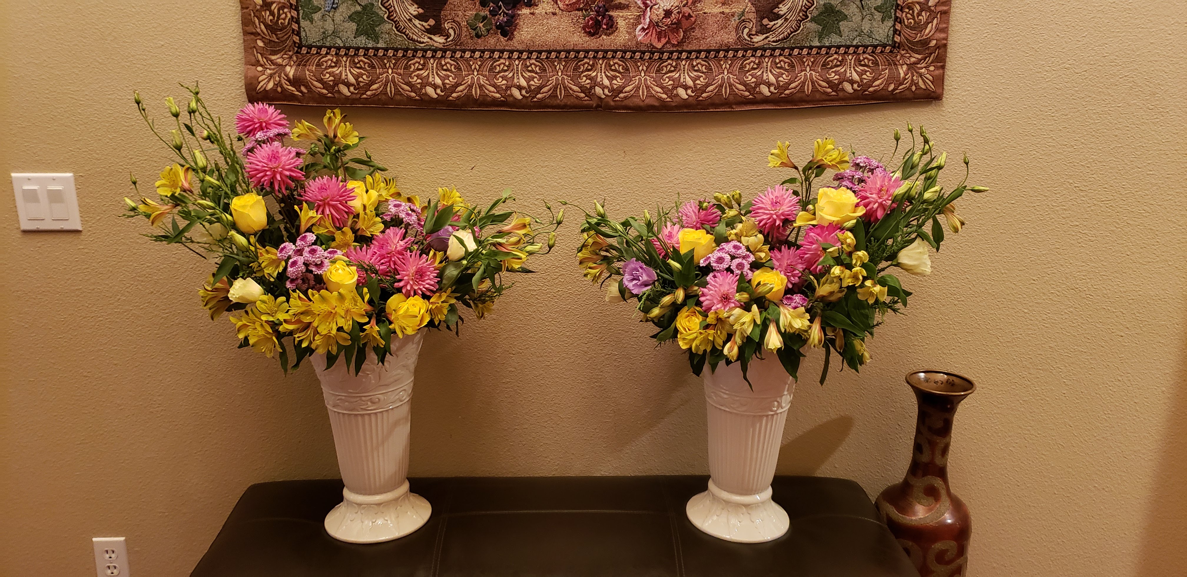 Pink Dahlias, Yellow Roses, Yellow Alstroemeria (Peruvian Lilies), Light Purple Lisianthus, Lavender & White Button Mums (Cushion Pompons), Pale green and Peach Zinnias, Salal, Tri-Color Dappled Willow, Cypress